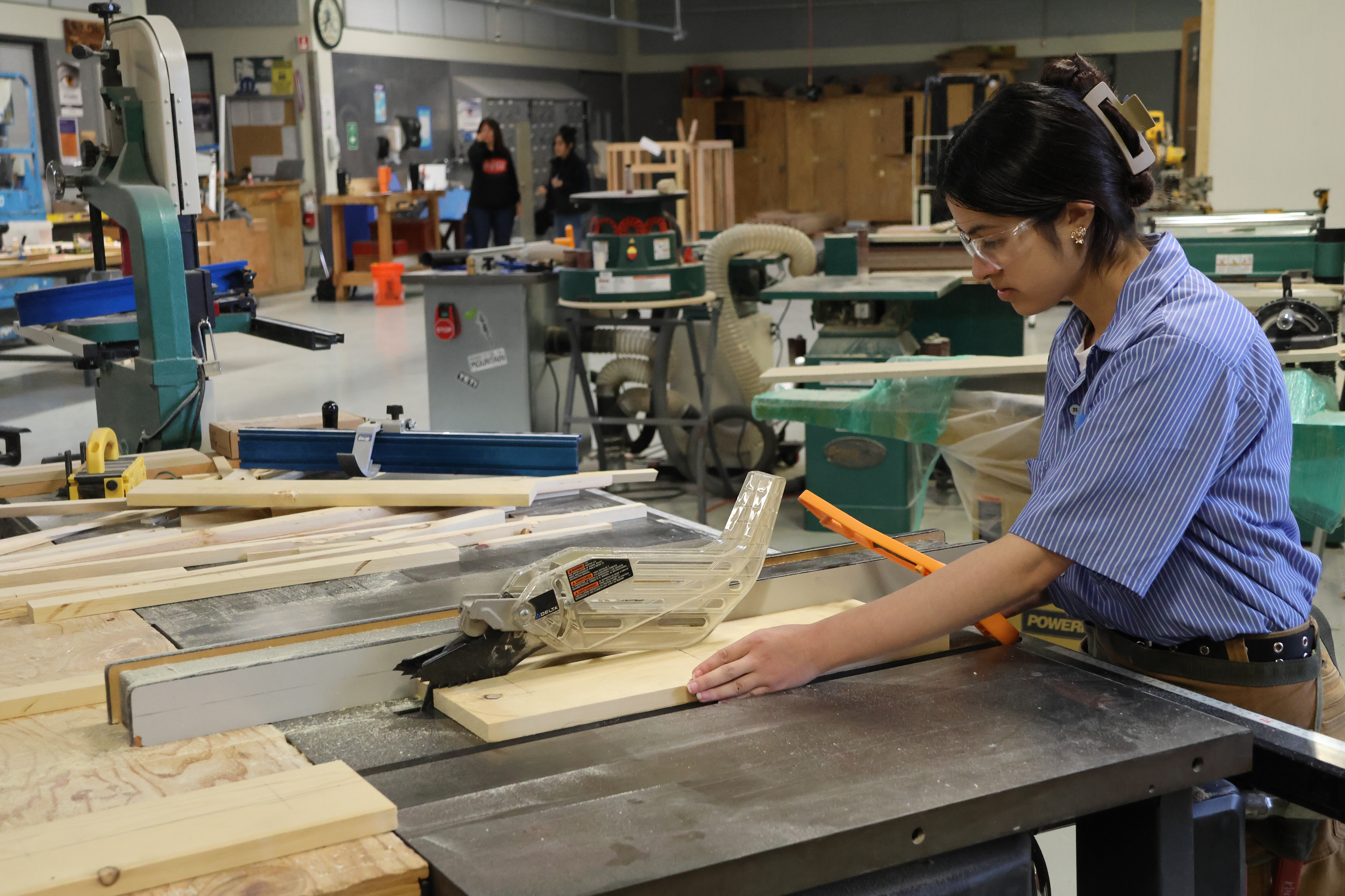 Construction student using equipment